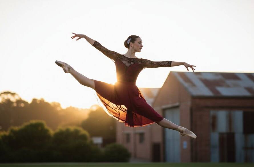 A dancer in a dramatic, athletic pose mid-air, bathed in golden hour light, performing against a blurred industrial Eumemmerring backdrop, showcasing the power of dynamic dance portraits Eumemmerring Victoria.