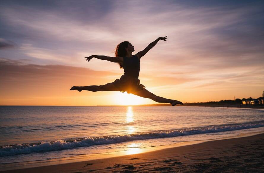 A powerful, epic moment captured in Edithvale dance photography that tells your unique story, showing a contemporary dancer in a dynamic leap against the backdrop of a vibrant sunset over Edithvale Beach, her form silhouetted and illuminated by dramatic golden hour light, conveying passion and grace.