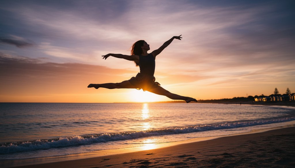 A powerful, epic moment captured in Edithvale dance photography that tells your unique story, showing a contemporary dancer in a dynamic leap against the backdrop of a vibrant sunset over Edithvale Beach, her form silhouetted and illuminated by dramatic golden hour light, conveying passion and grace.