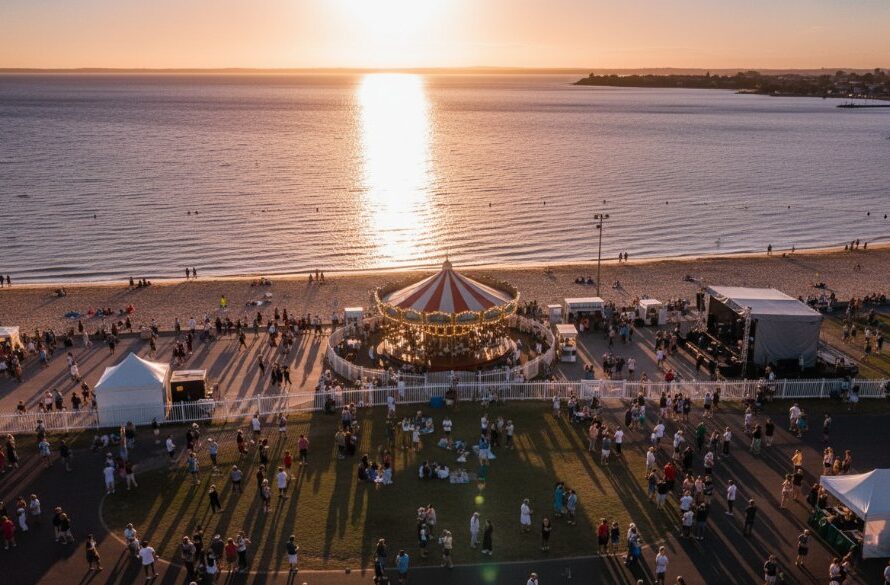 An epic drone shot capturing a vibrant outdoor event along Geelong's waterfront, with the 'Elevate Geelong events drone photography Victoria' perspective, showcasing colourful crowds, sparkling bay waters, and dramatic sunset light.