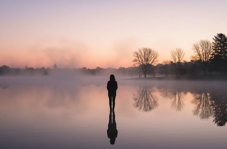 An emotionally resonant, wide-angle fine art photograph capturing a couple's silhouette against a dramatic sunset over Lake Wendouree, embodying the beauty of elevated Wendouree memories fine art photography, with professional colour grading.