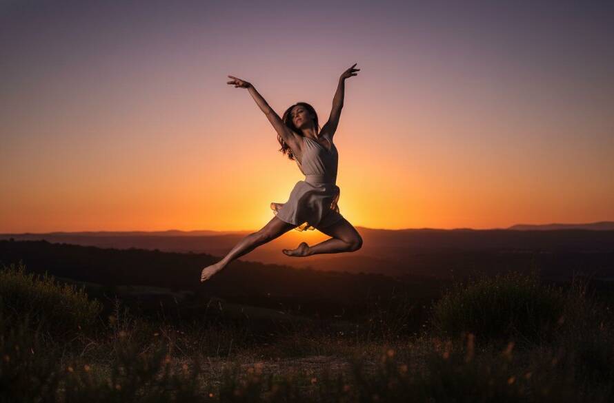 Dynamic shot of a contemporary dancer mid-leap, silhouetted against a golden sunset over the Dandenongs from Endeavour Hills, showcasing professional Endeavour Hills dance photography capturing epic moments.