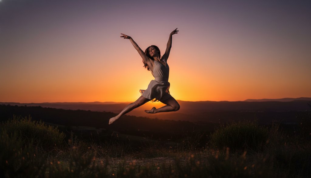 Dynamic shot of a contemporary dancer mid-leap, silhouetted against a golden sunset over the Dandenongs from Endeavour Hills, showcasing professional Endeavour Hills dance photography capturing epic moments.
