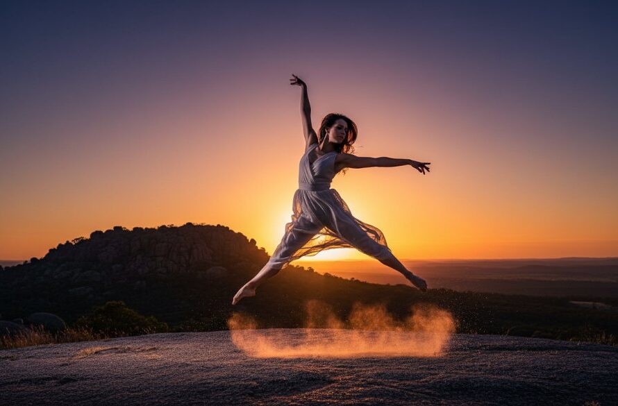 A dancer leaps gracefully at sunset amidst the rugged natural beauty of Black Hill, Victoria, showcasing epic dance photography moments in Black Hill Victoria with dramatic lighting and professional colour grading.