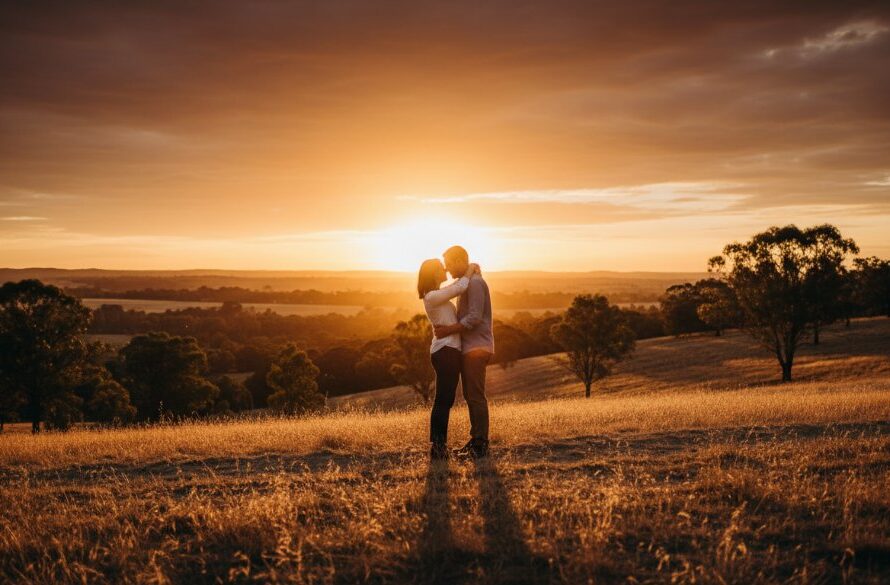 A couple shares a tender moment amidst the golden light of the Eureka goldfields, featuring authentic Eureka Victoria rustic engagement photography capturing their love story.