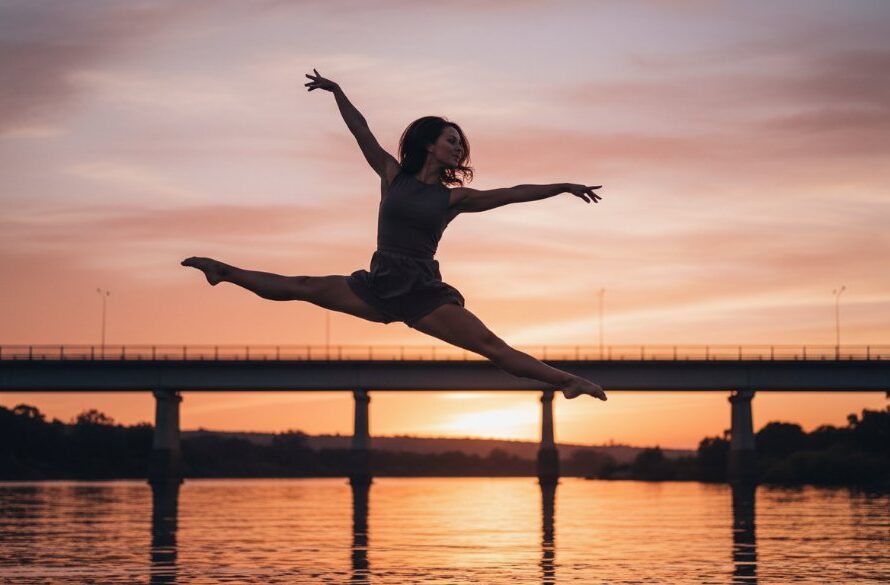 An epic moment of a contemporary dancer captured with expressive dance photography Orbost Victoria, performing a powerful leap against a soft-focused backdrop of the Orbost Bridge at sunset, showcasing incredible athleticism and artistry with dramatic lighting and professional colour grading.