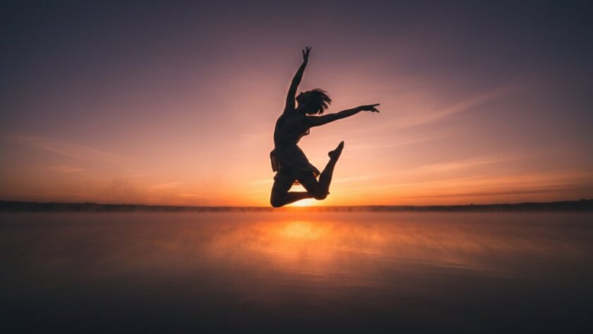 A stunning, dramatically lit epic moment capture of a contemporary dancer mid-leap against a misty Colac Victoria backdrop, embodying expressive dance portraits Colac Victoria with grace and power.