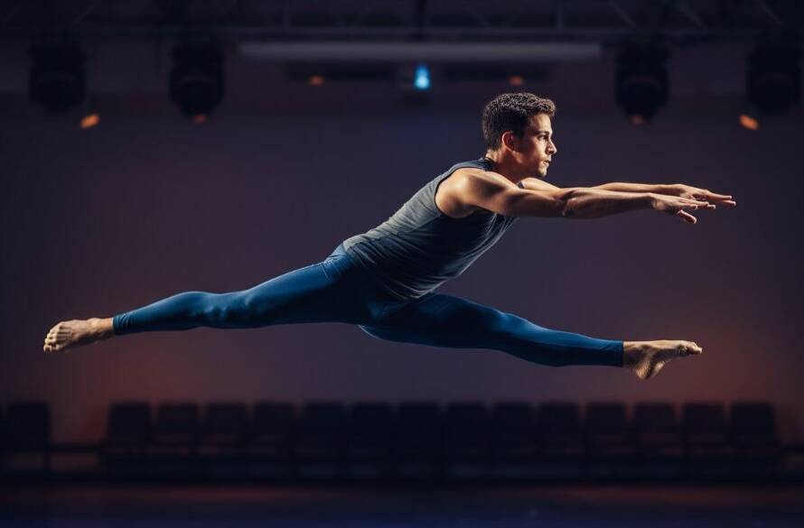 A breathtaking, high-energy studio shot in Hallam, Victoria, showcasing Hallam dance photography capturing movement, with a dancer mid-air in a dramatic leap, illuminated by powerful stage-like lighting and a professionally color-graded finish.