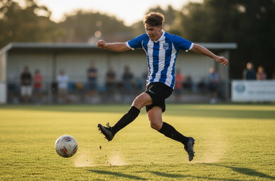 Dynamic wide-angle shot of a young athlete scoring a goal during a Hamlyn Heights youth sports action photography session, with dramatic lighting highlighting their determined expression and the blurred background of the Hamlyn Heights sports oval.