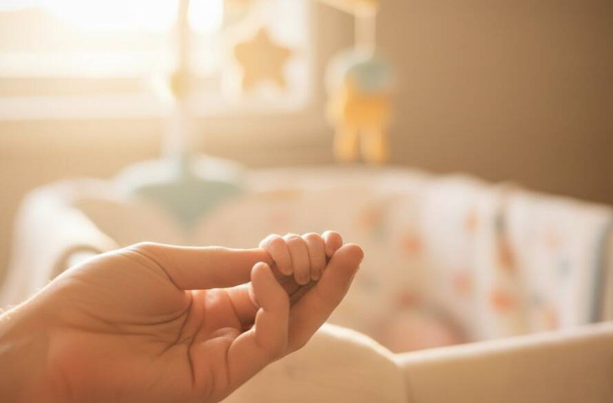 An intimate, emotionally resonant 'epic moment' photograph capturing heartfelt newborn photography Berwick, showing a tiny baby's hand gently grasping a parent's finger, bathed in soft, golden window light, in a serene Berwick home setting.