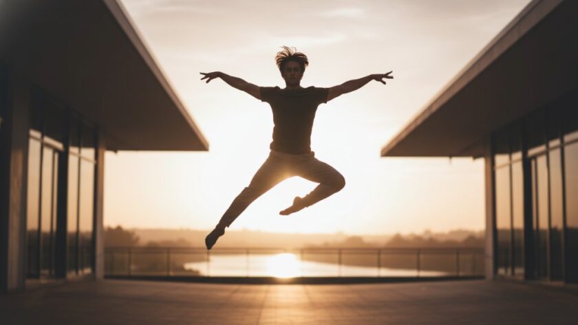 A male dancer in peak performance, mid-leap with dramatic lighting, embodying the essence of Highton Victoria dynamic dance photography against a blurred background, capturing an epic moment of athleticism and grace.