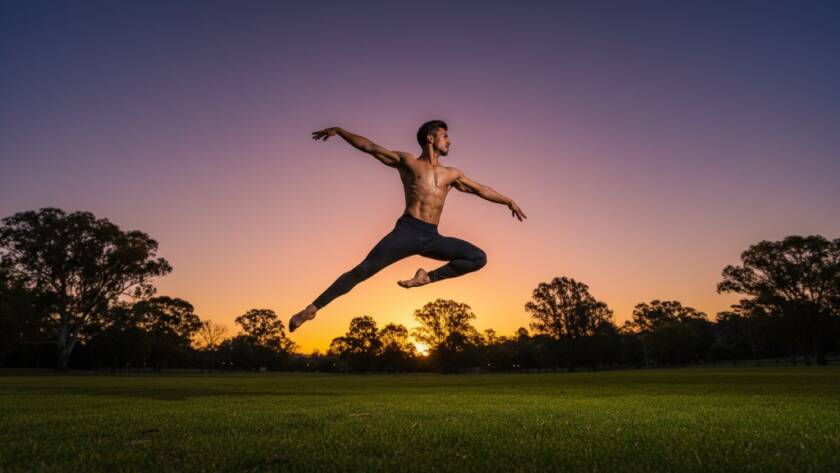 An epic moment captured in Hillside Victoria captivating dance photography for artists, featuring a dancer in mid-air, bathed in golden hour light against a lush, green Hillside park backdrop, showcasing power and grace.