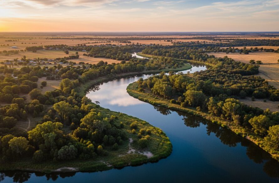 An epic moment captured by professional drone photography, showcasing the majestic Horsham Wimmera River at sunrise, with golden light reflecting off the tranquil water and illuminating the lush riverbanks, highlighting the beauty only Horsham Wimmera River drone photography can reveal.