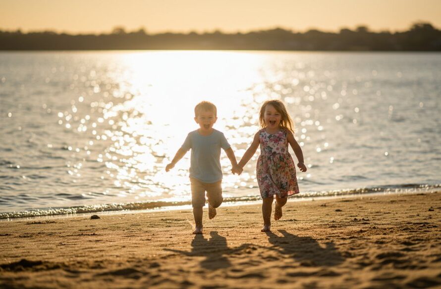 Epic moment of two children laughing as they run along the golden sands of Yarrawonga foreshore at sunset, captured with joyful kids photography Yarrawonga foreshore, dramatic backlighting.