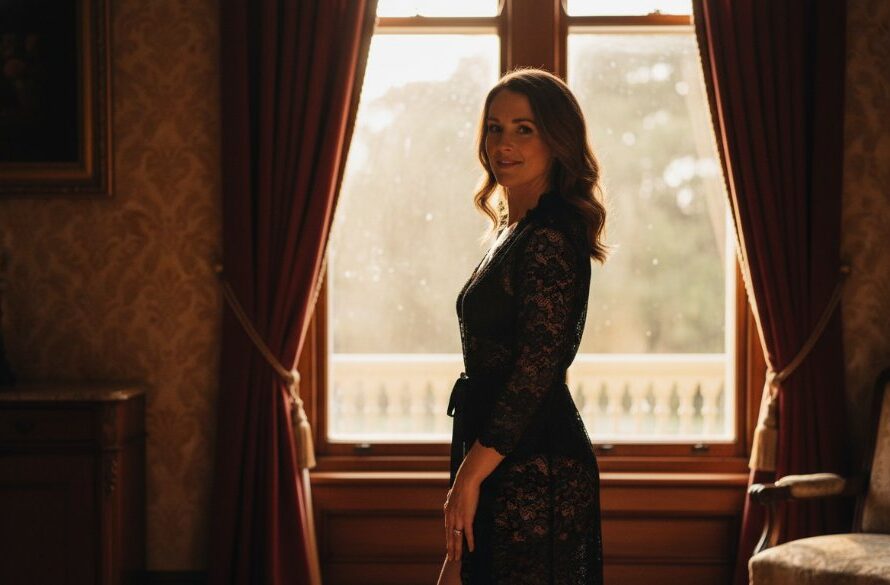 A stunning, soft-focused portrait of a woman bathed in dramatic natural light, evoking a luxurious boudoir photography experience in Eureka, Victoria. She looks confidently over her shoulder, a sheer fabric draped elegantly, showcasing an 'epic moment' of self-assured beauty.