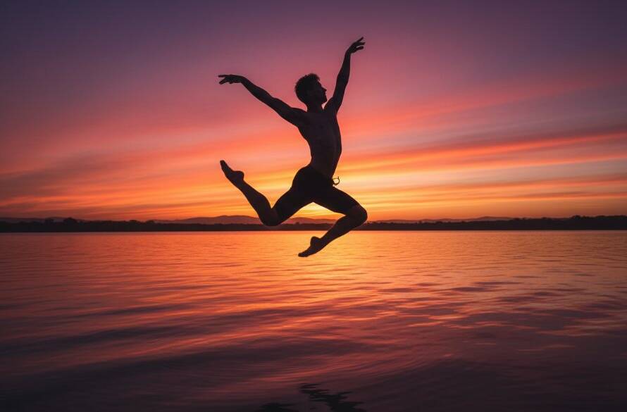 A powerful, wide-angle shot of a contemporary dancer mid-leap against a dramatic sunset backdrop over Lysterfield Lake, capturing the essence of Lysterfield dance photography for vibrant performances with cinematic lighting and a sense of artistic freedom.