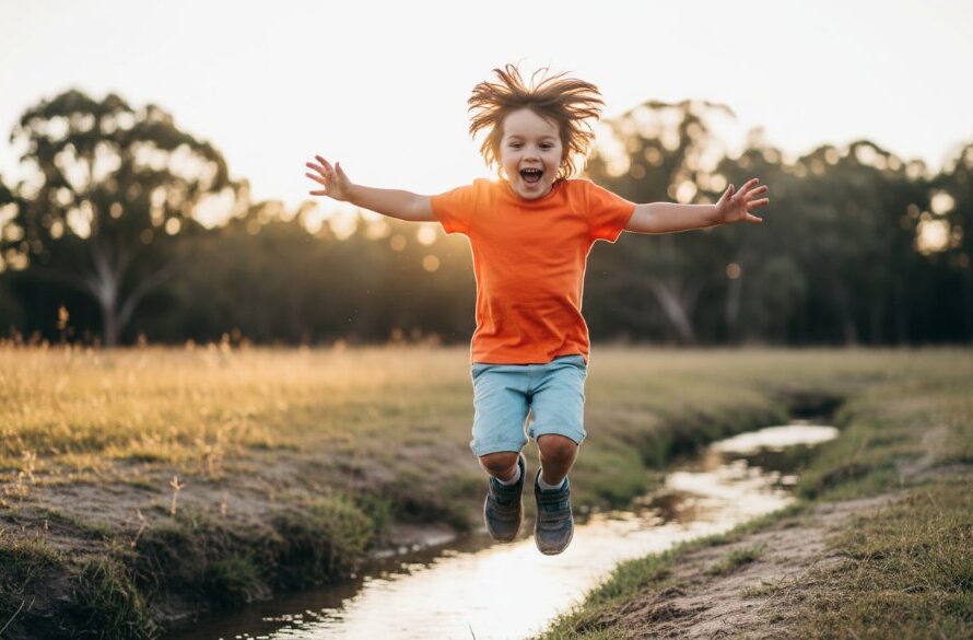 A vibrant, low-angle Marong Victoria kids photography joyful outdoor portraits moment, capturing a child with an explosion of pure joy, mid-run through a sun-drenched field near Marong, golden hour light, professional cinematic feel.