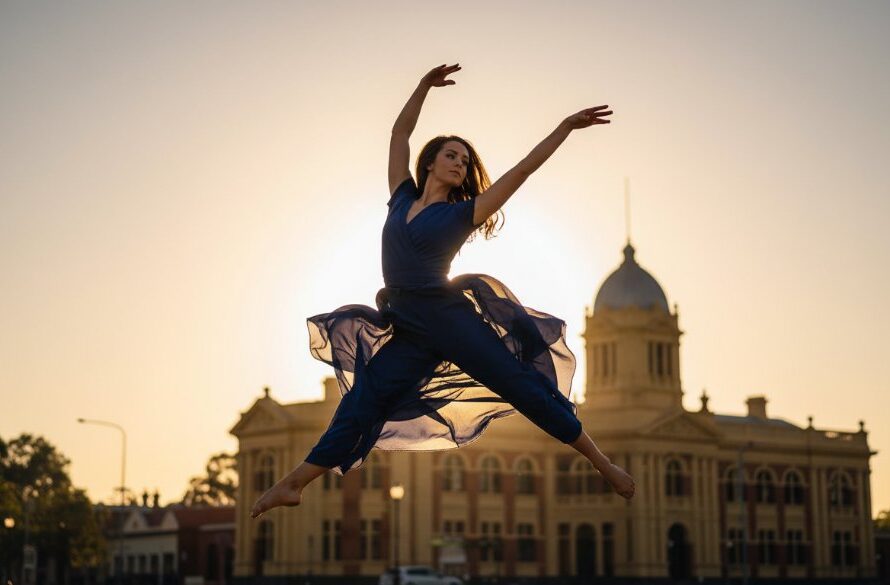 Dynamic wide shot of a ballet dancer mid-leap at sunset in Maryborough, Victoria, perfectly showcasing Maryborough Victoria dance photography capturing graceful motion, with the historic streetscape softly blurred in the background, dramatic golden hour lighting, professional colour grading.