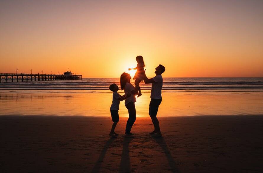 An ecstatic Mentone Beach family photographer capturing candid joy, showing parents lifting their laughing child at sunset on the sandy shore, with golden light reflecting on the water, portraying a heartwarming, professional portrait.