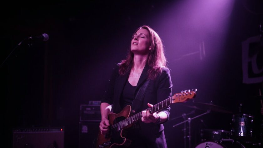 Dynamic shot capturing a lead singer mid-performance on a Merbein stage, bathed in dramatic stage lights, showcasing Merbein live music photography expertise.