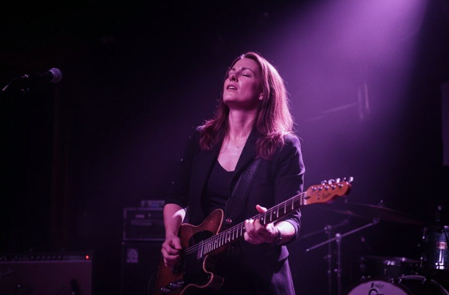 Dynamic shot capturing a lead singer mid-performance on a Merbein stage, bathed in dramatic stage lights, showcasing Merbein live music photography expertise.
