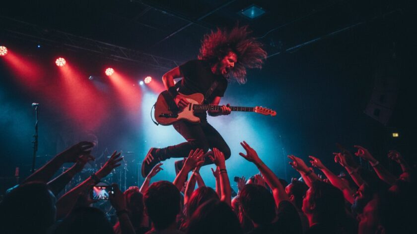 An electrifying wide-angle shot of a lead guitarist mid-shred under dramatic stage lights at a vibrant Moe Victoria electrifying live music photography event, capturing the energy of the crowd and dynamic motion.