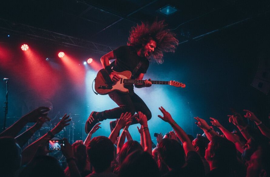 An electrifying wide-angle shot of a lead guitarist mid-shred under dramatic stage lights at a vibrant Moe Victoria electrifying live music photography event, capturing the energy of the crowd and dynamic motion.