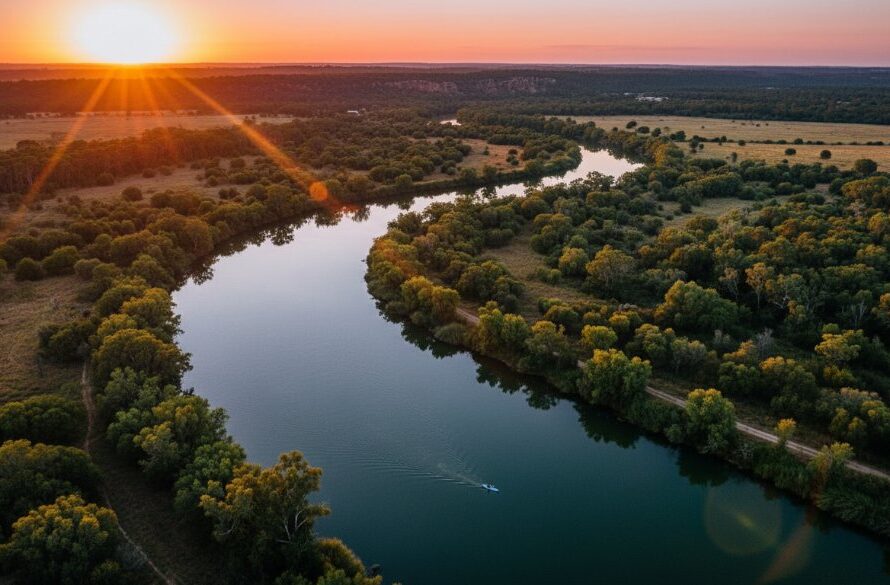Dramatic aerial view of the Goulburn River winding through lush Mooroopna riverbend drone photography landscapes at sunset, golden light illuminating the water and dense bushland, capturing an epic moment of natural beauty.