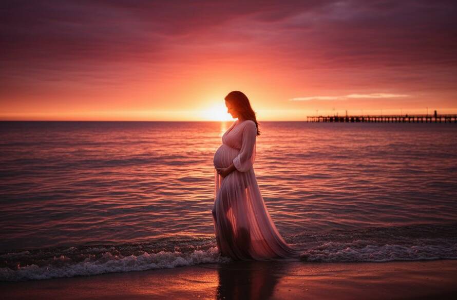 A breathtaking Mordialloc Beach maternity photography sunset glow portrait featuring a pregnant woman silhouetted against a vibrant orange and purple sky, standing by the water's edge with gentle waves, her hands cradling her belly, evoking serene anticipation and the beauty of impending motherhood, professionally captured with dramatic lighting.
