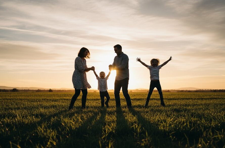An epic moment of a joyful Australian family, parents laughing as their children run through a sun-dappled field at sunset in Mount Clear, Victoria, perfectly encapsulating Mount Clear family photography capturing genuine joy.