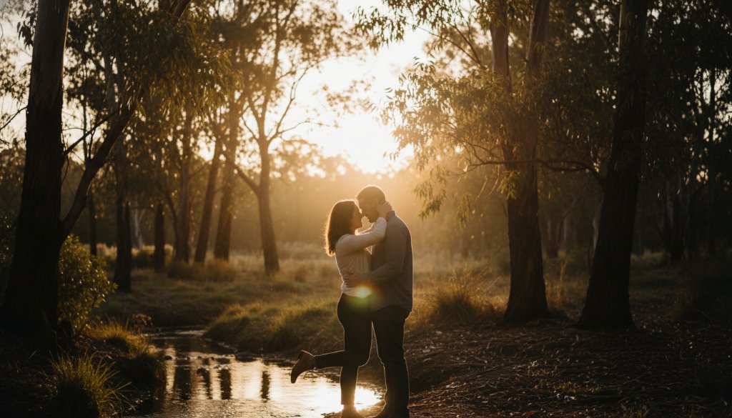 A newly engaged couple sharing a tender, epic moment at sunset, framed by lush greenery and historical architecture in one of Mount Waverley picturesque engagement photoshoot locations, captured with dramatic lighting.