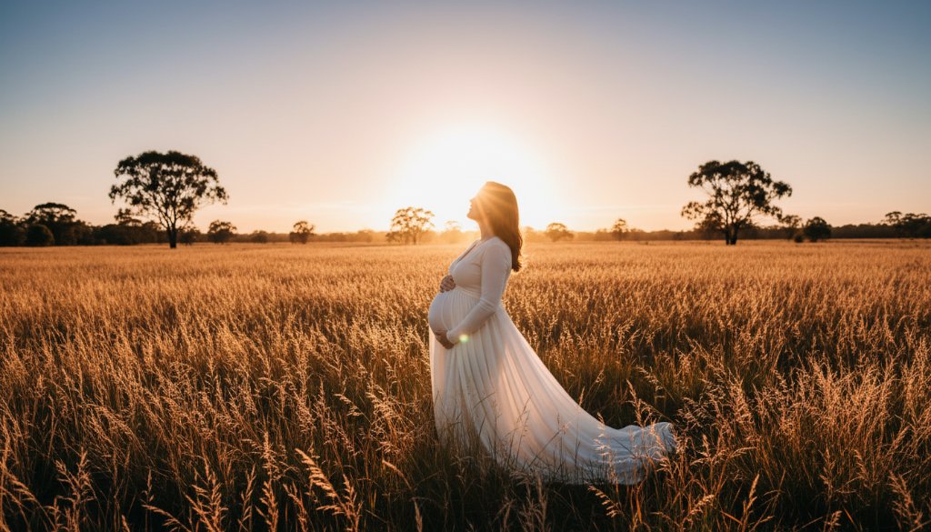 A radiant expectant mother in Mulgrave, Victoria, during an outdoor maternity photoshoot, her silhouette dramatically lit by golden hour sun filtering through eucalyptus trees, embodying an epic moment of serene anticipation.