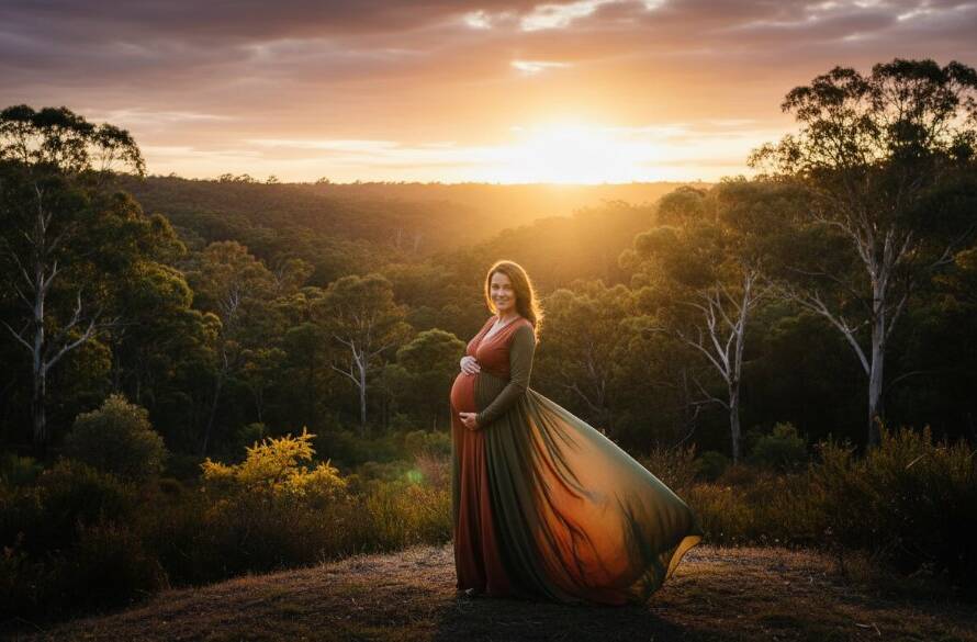 A pregnant woman, bathed in golden hour natural light Wonga Park maternity photography, stands majestically amidst lush Australian bushland at sunset, her silhouette framed by towering gum trees, symbolising the epic journey of motherhood with dramatic and professional color grading.
