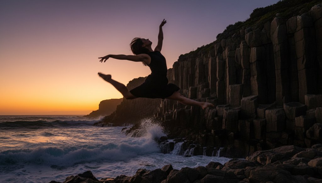 A professional photograph capturing a dancer in an epic, dynamic leap over the rugged coastline near Portland, Victoria, showcasing the power of Portland Victoria dynamic dance photography with dramatic sunset lighting.