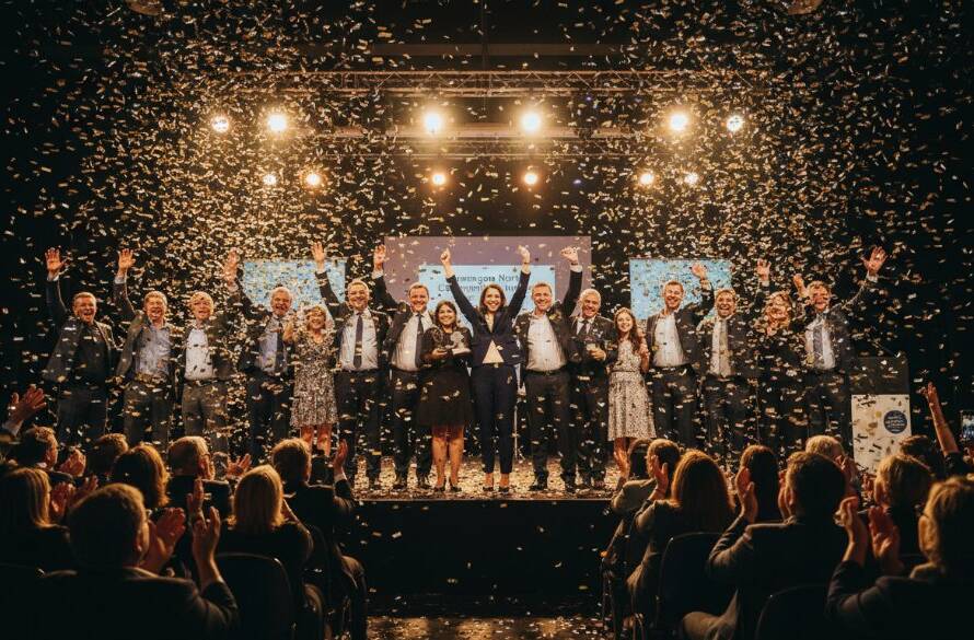 A candid, wide-angle shot capturing the sheer joy and energy of a community festival in Dandenong North, featuring a diverse crowd cheering, vibrant decorations under golden hour sunlight, with confetti showering. Professional event photography Dandenong North success encapsulated in an epic, emotion-filled moment.