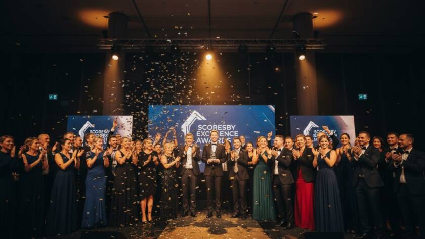 An epic moment captured by professional event photography Scoresby Victoria, featuring a group of jubilant attendees cheering at a corporate gala dinner in a beautifully lit Scoresby venue, celebrating a significant achievement.
