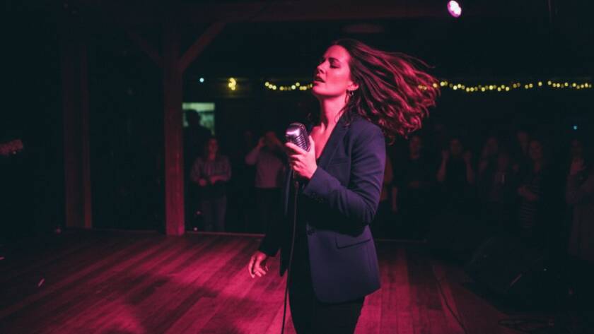 An electrifying close-up shot of a lead guitarist performing on stage at a Heatherdale venue, bathed in dramatic red and blue stage lighting, capturing the intense passion and energy of a live local music event, perfect for professional Heatherdale concert photography capturing live local music energy.