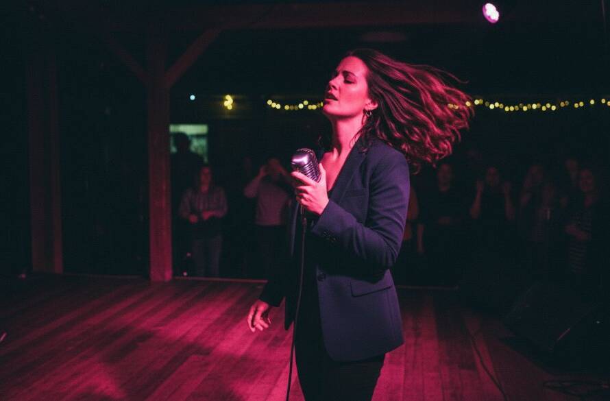 An electrifying close-up shot of a lead guitarist performing on stage at a Heatherdale venue, bathed in dramatic red and blue stage lighting, capturing the intense passion and energy of a live local music event, perfect for professional Heatherdale concert photography capturing live local music energy.