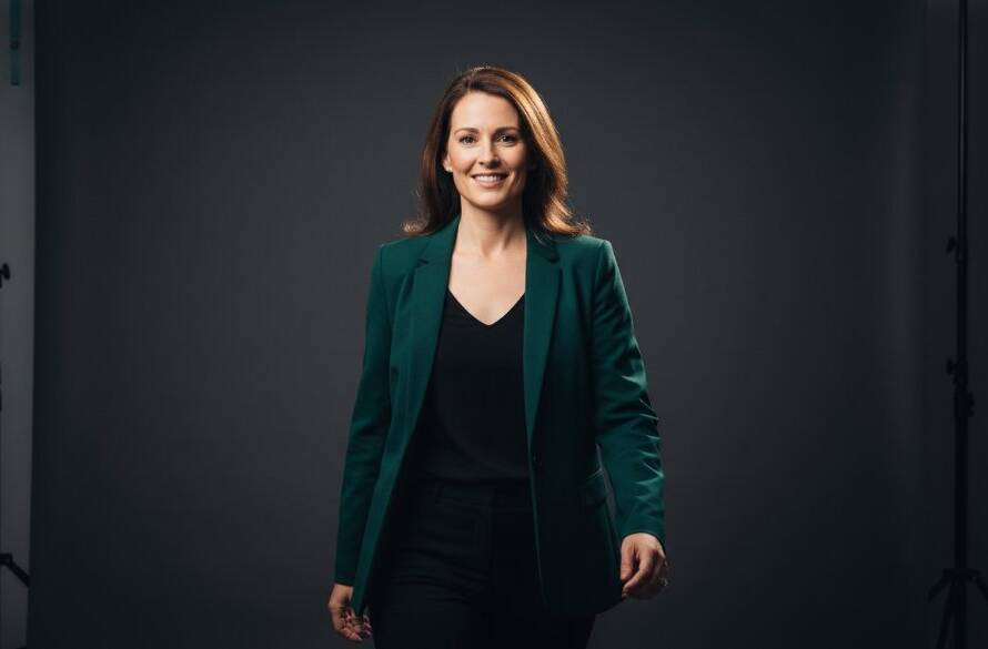 A striking professional studio portraits Box Hill for vibrant personal branding showcasing a confident entrepreneur mid-laugh, bathed in dramatic, soft key light with a subtle rim light, against a minimalist charcoal backdrop, conveying authenticity and approachable authority.