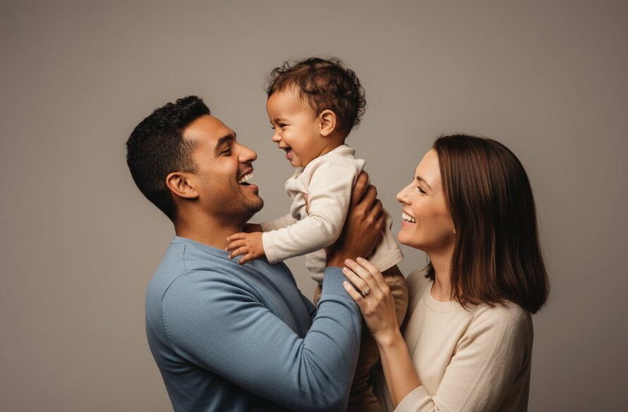 A joyous Red Cliffs family in a professionally lit studio, captured in an epic moment during their Red Cliffs studio portraits capturing family joy session. The father lifts his child high, both laughing heartily, with the mother looking on lovingly, showcasing genuine connection and professional colour grading.