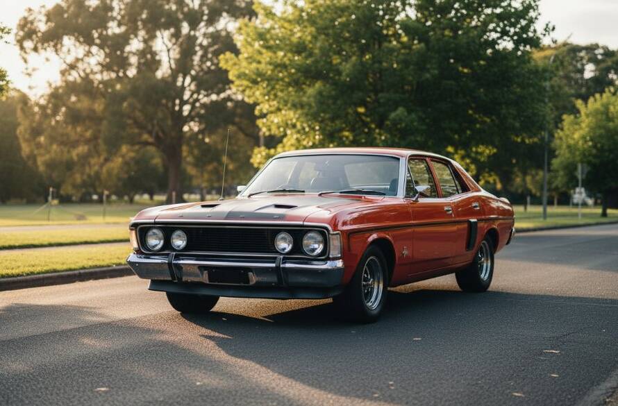 An epic moment of Ringwood automotive photography capturing vehicle soul: a gleaming classic muscle car dramatically lit at dusk, parked on a winding road with the distant glow of Ringwood's urban fringe.