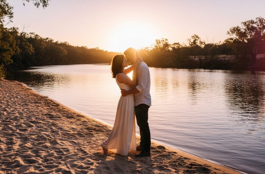 An epic, emotionally charged moment during a romantic Cobram engagement photoshoot Murray River, featuring a couple embracing passionately at sunset on a sandy bank, with dramatic golden light reflecting on the water, highlighting their love story.