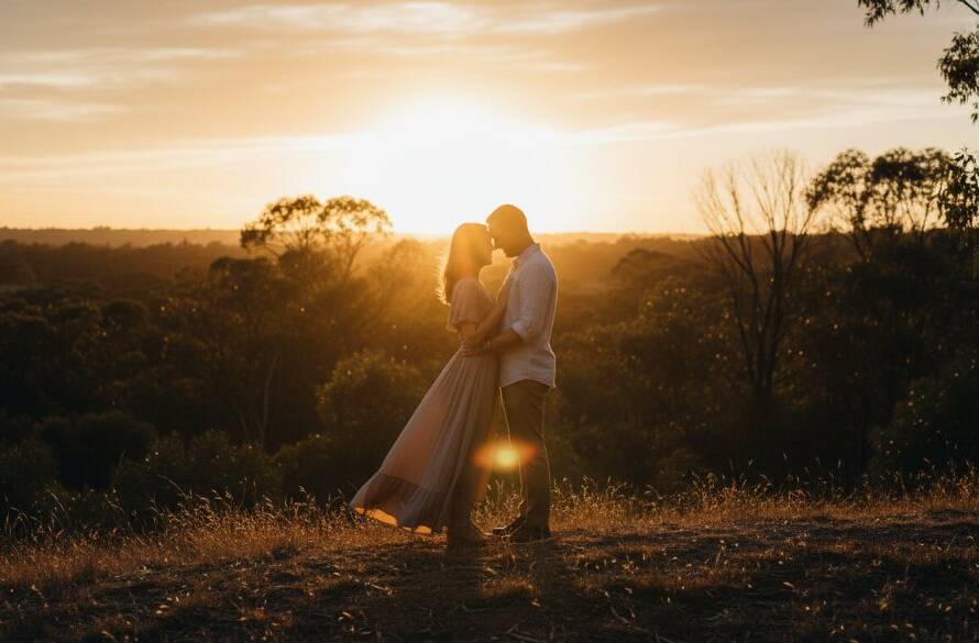 An intimate and romantic Croydon South engagement photography adventure moment, featuring a couple embracing softly at sunset in a beautiful, natural park setting, with golden light filtering through trees, expertly composed to capture their deep connection.