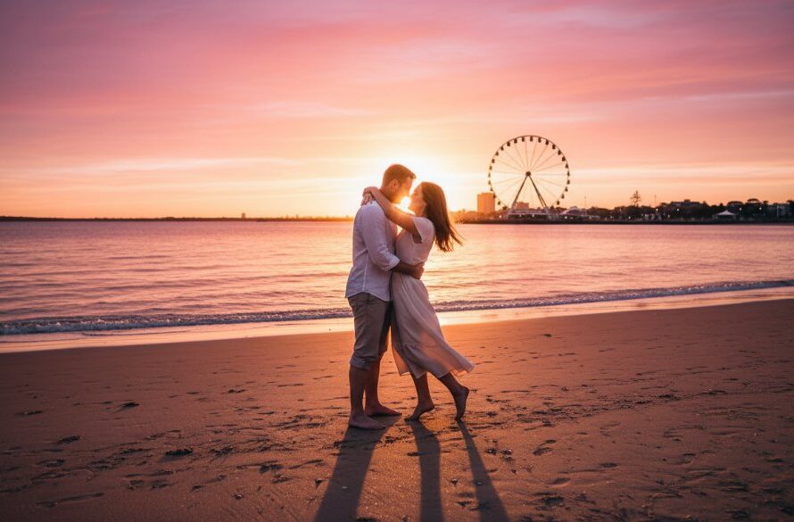 A stunning 'epic moment' style photograph of a couple embracing passionately at sunset on Eastern Beach, Geelong, with the iconic Ferris wheel in the background, showcasing romantic Geelong engagement photoshoot ideas. The dramatic golden hour lighting creates long shadows and a warm glow, professionally colour-graded for a cinematic feel.