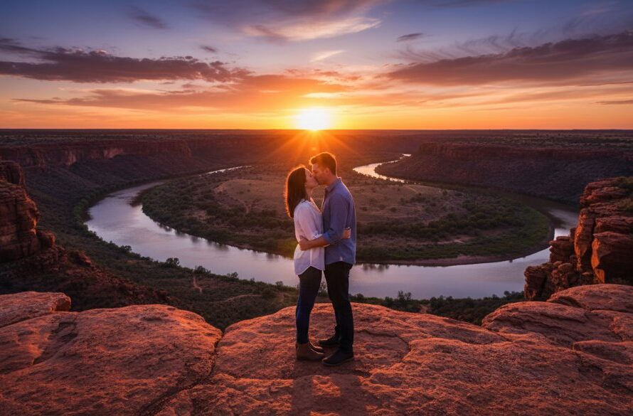 An epic, wide-angle shot capturing a couple sharing a tender kiss at sunset amidst the iconic red cliffs of Red Cliffs, Victoria, silhouetted against a vibrant orange and purple sky, showcasing romantic Red Cliffs sunset engagement photography at its finest.