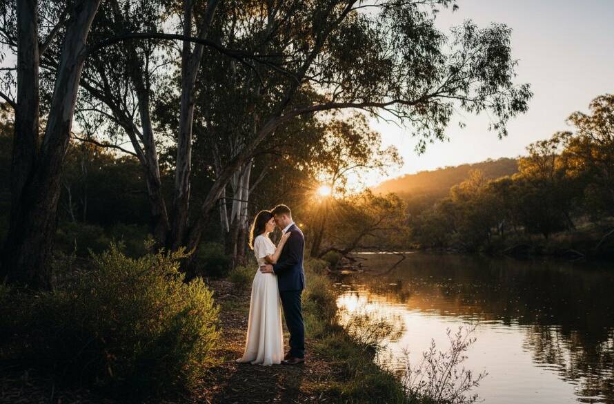 An epic, cinematic moment captured during a romantic Warrandyte riverside pre-wedding photography session, featuring a couple embracing near the golden hour riverbanks, dramatic light.