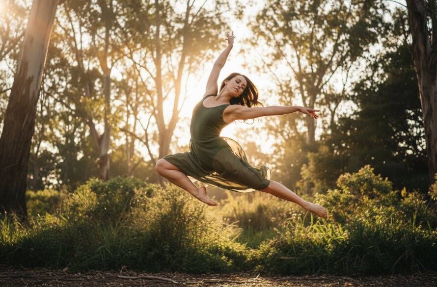 Dramatic professional photograph featuring a dancer in dynamic mid-air motion, showcasing an epic moment from a Scoresby contemporary dance photoshoot experience, with warm backlighting and a blurred Scoresby park background.