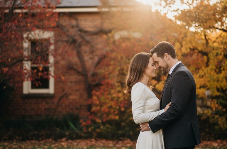 An epic, professionally color-graded photograph capturing a couple embracing amidst the golden hour glow in Sebastopol, showcasing a romantic pre-wedding photography experience, with the historic Sebastopol Town Hall in the softly blurred background.