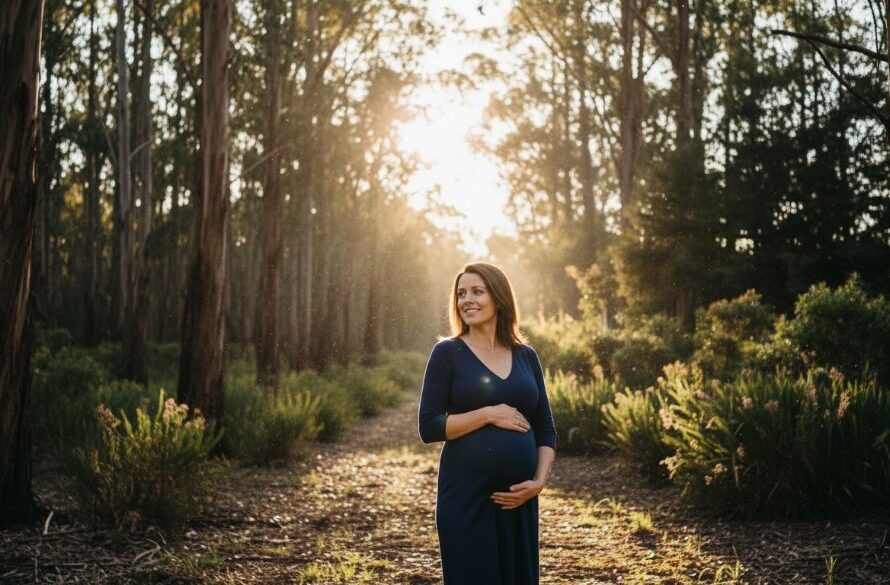 A breathtaking, cinematic photograph showcasing serene Canadian Victoria maternity photography bushland, with an expectant mother silhouetted by the golden hour sun filtering through eucalyptus trees, capturing a moment of profound peace and natural beauty.