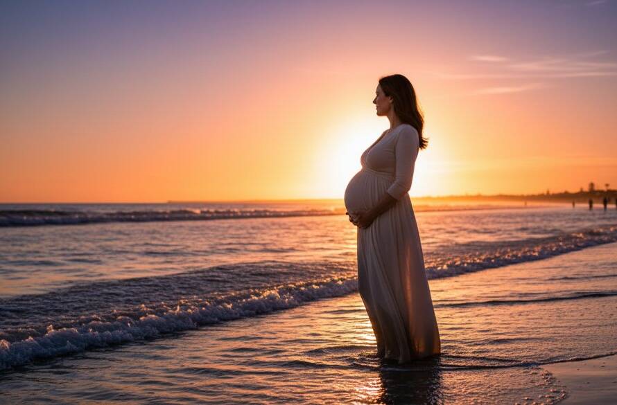 A pregnant woman, beautifully silhouetted against a golden hour sunset over Chelsea Beach, embodying the serenity of serene maternity photoshoots Chelsea Beach Victoria, with soft waves lapping the shore.